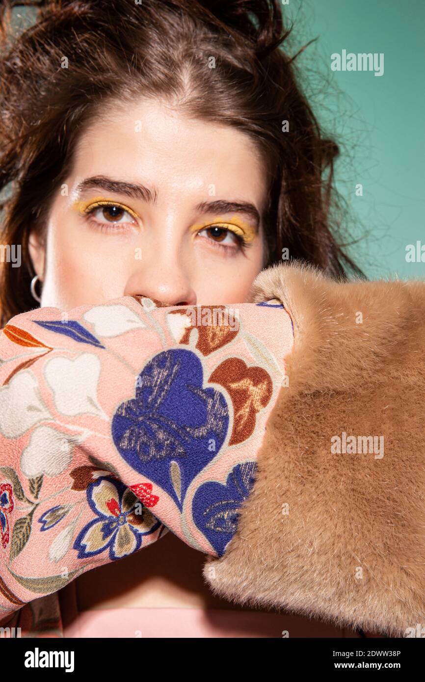 Girl covering her face with a sleeve portrait portrait isolated on ...