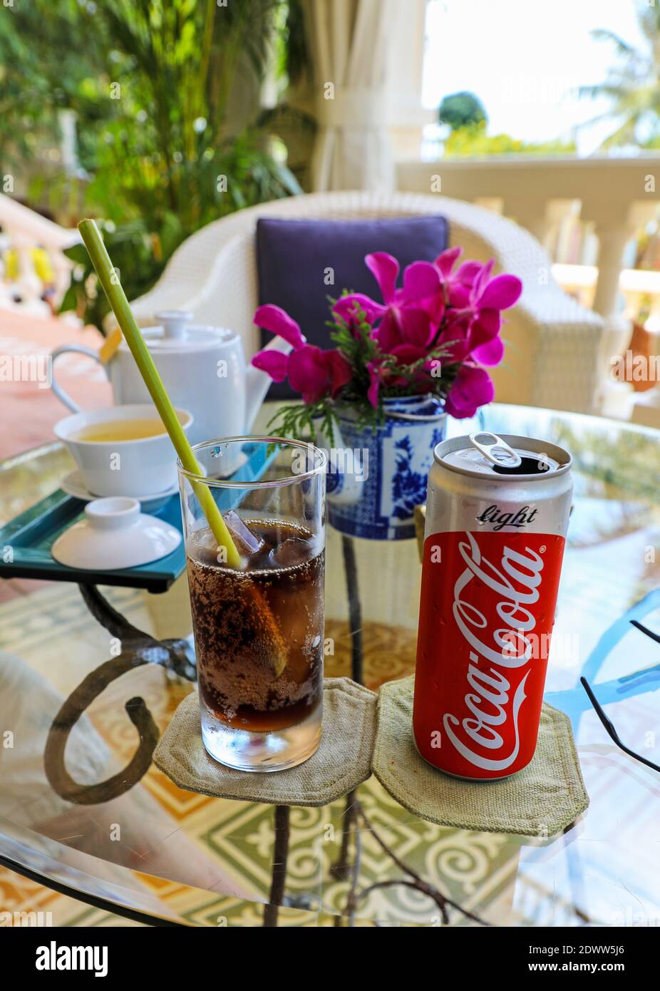 Can of Coca Cola light or diet Coke, glass with environmentally friendly straw made from stalk of a plant, La Veranda Resort, Phu Quoc, Vietnam, Asia Stock Photo