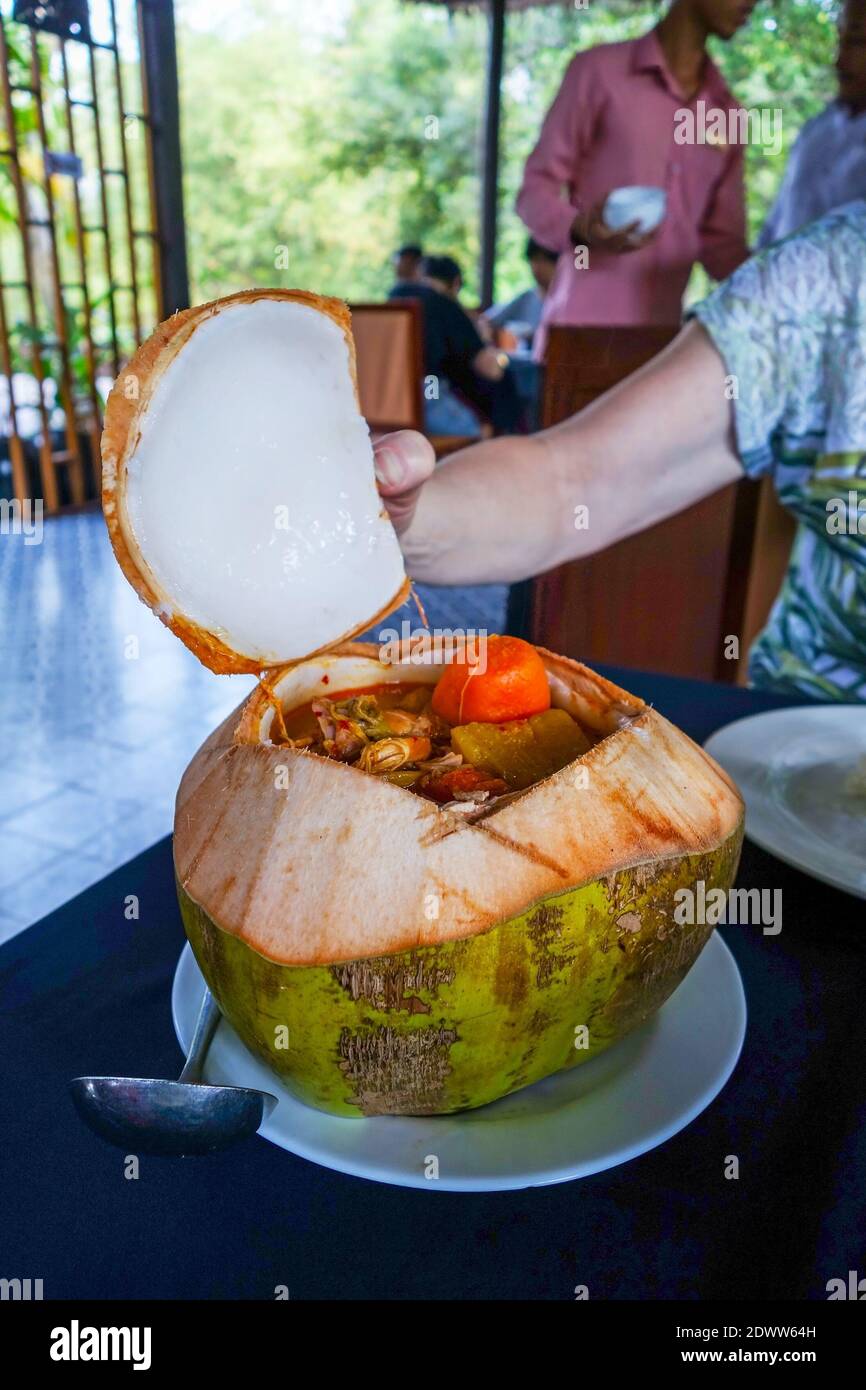 A meal in a Cambodia restaurant comprising meat and vegetables in a hollowed out coconut shell, Cambodia, Asia Stock Photo