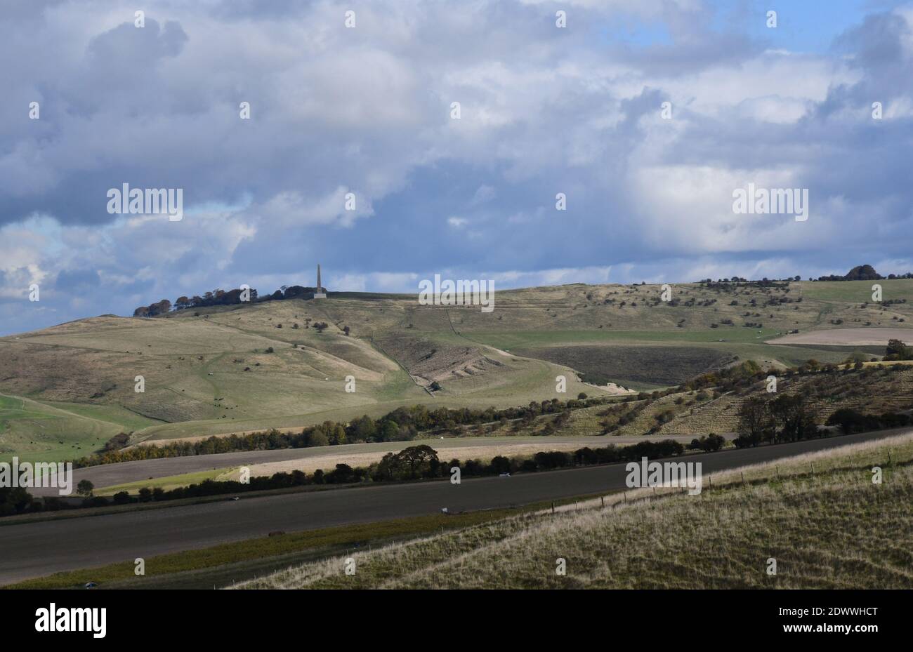 View from Morgans Hill towards the Lansdowne monument on Cherhill Down with Calstone Down and rolling sun dappled fields in the foreground,Wiltshire.U Stock Photo