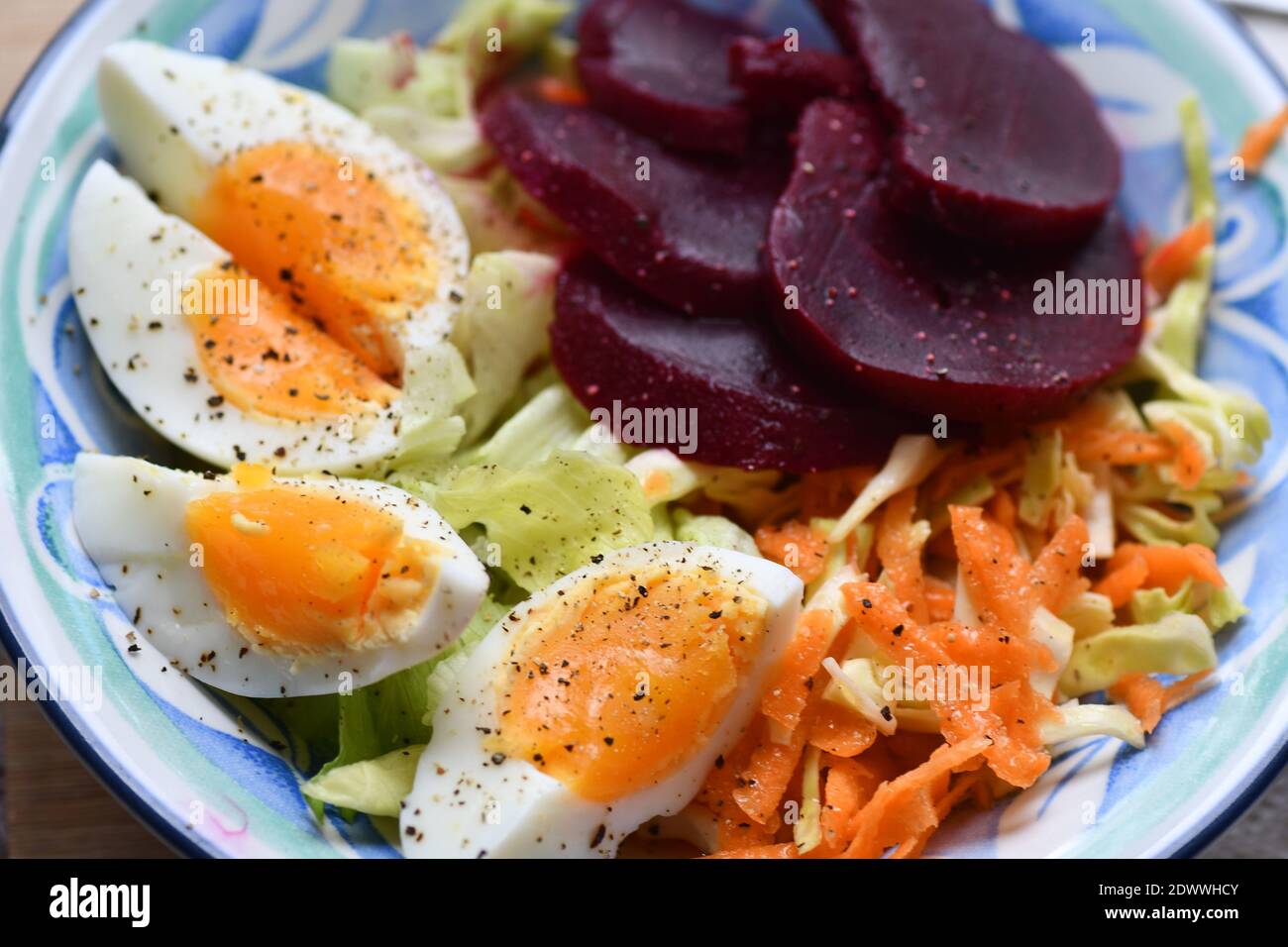 A colourful light lunch, of boiled egg, coleslaw, lettuce and beetroot. Stock Photo