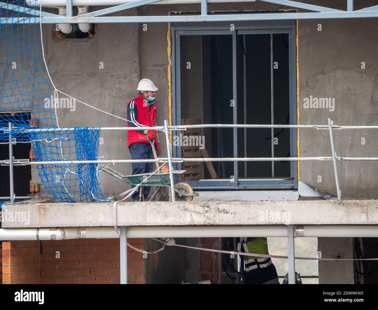 November, 16 2020, in Madrid, Spain, one construction worker is doing his job Stock Photo