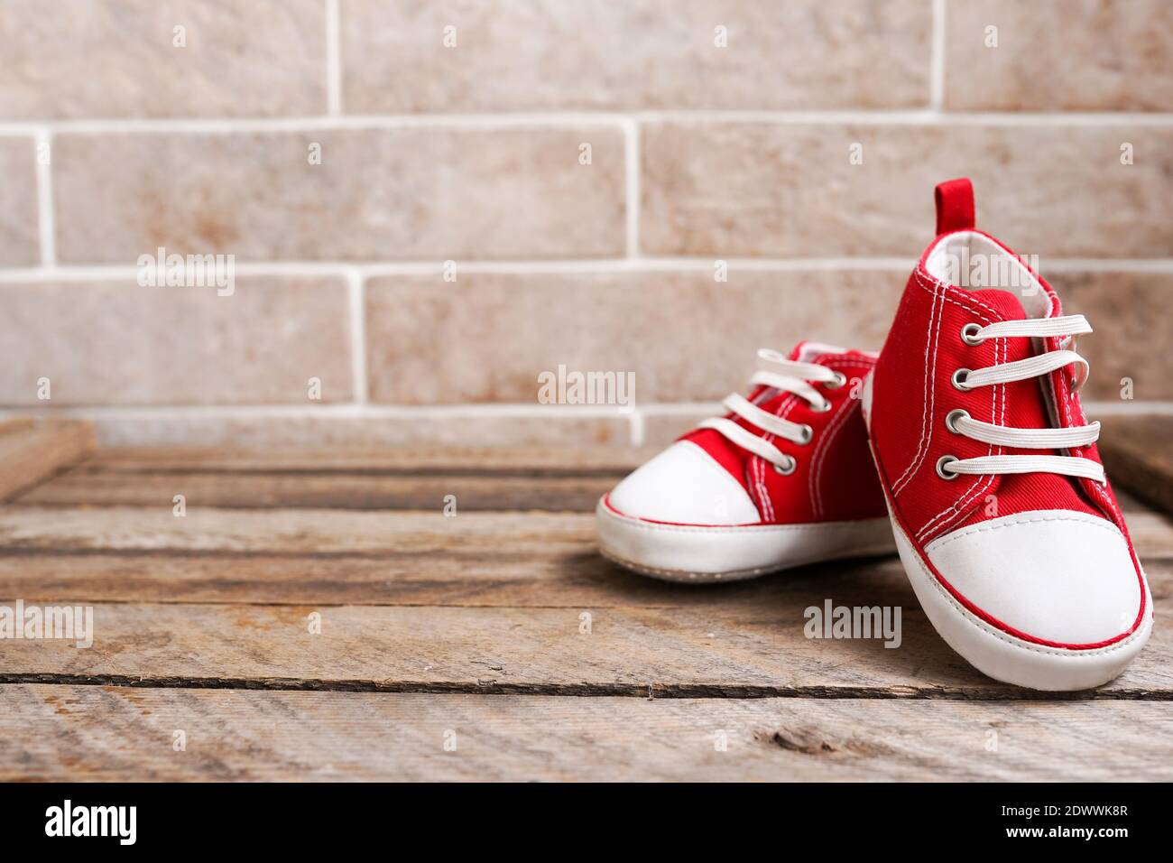 Baby shoes tied together hi-res stock photography and images - Alamy