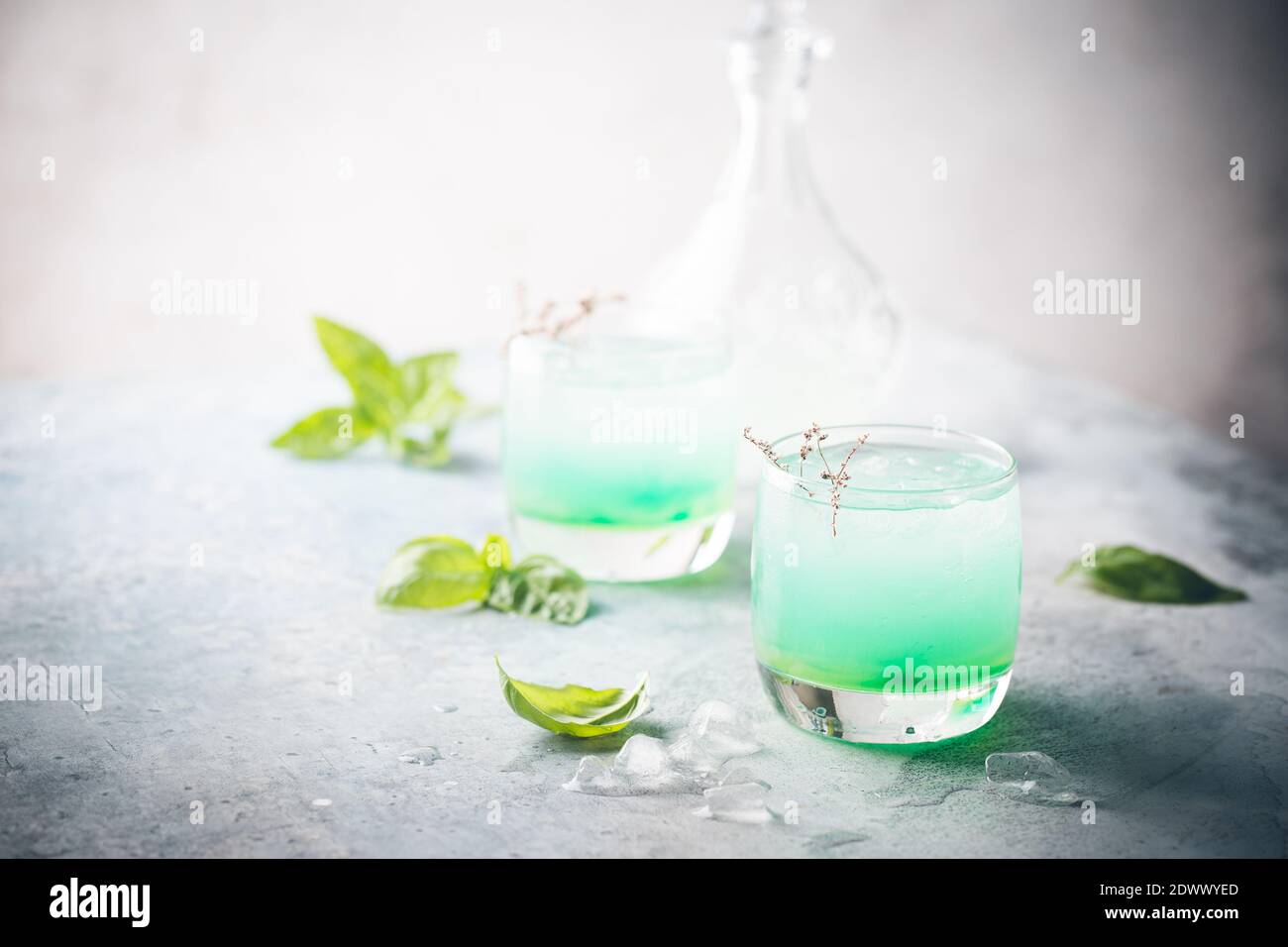 Cold summer drink with basil leaves in glasses. Mojito, iced tea