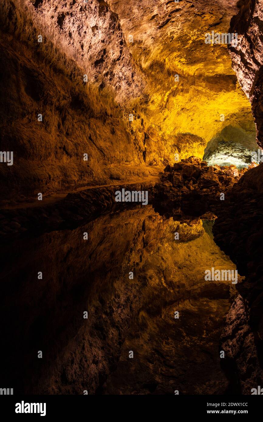 Cave reflection lava tube illuminated in Canary Islands. Geological cavern formation, tourist attraction concepts Stock Photo