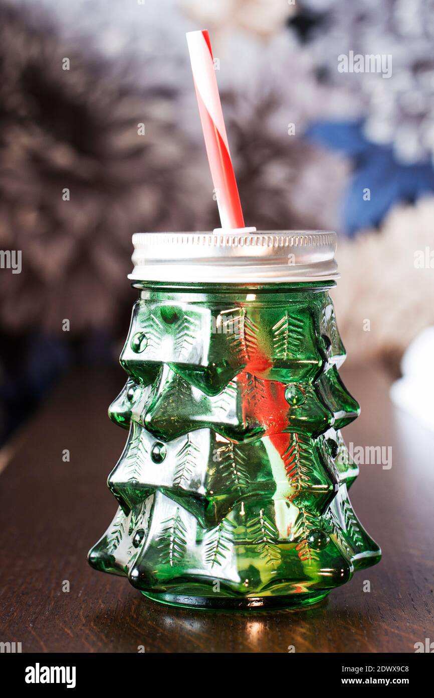 https://c8.alamy.com/comp/2DWX9C8/empty-glass-mason-jar-of-smoothies-in-the-form-of-christmas-tree-with-straws-on-wooden-table-and-color-background-glass-mug-for-juice-vegetable-smoo-2DWX9C8.jpg