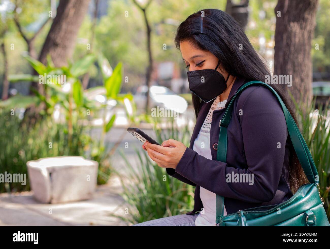 Latin businesswoman wearing a face mask for protective reasons during the covid 19 pandemic. Stock Photo