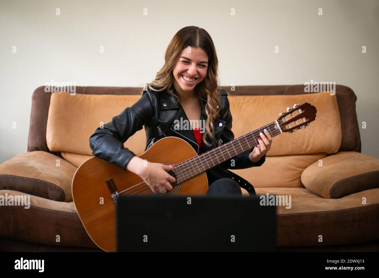 Girl Plays Guitar In Living Room