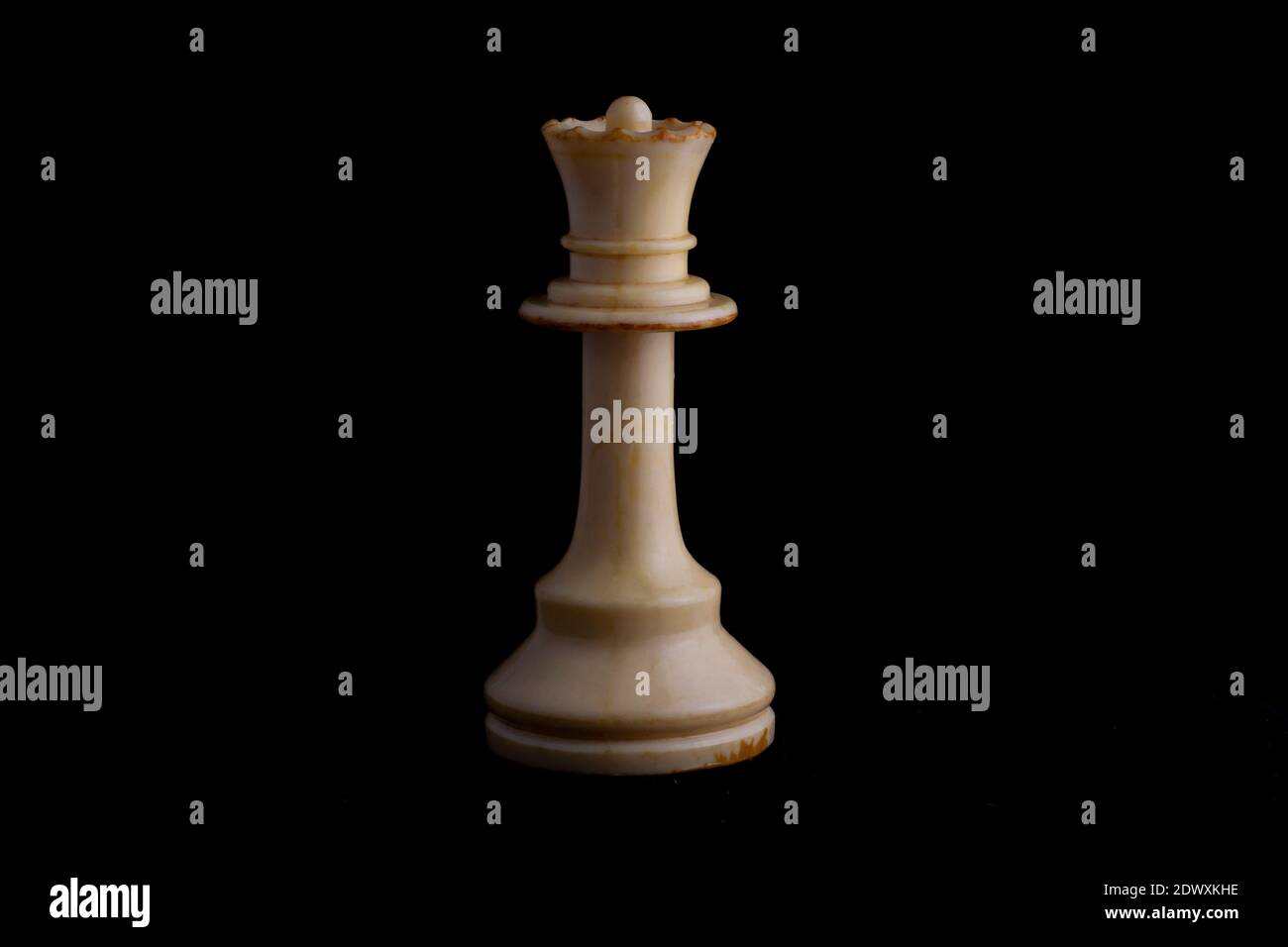 one side light on white queen chess piece in black background Stock Photo