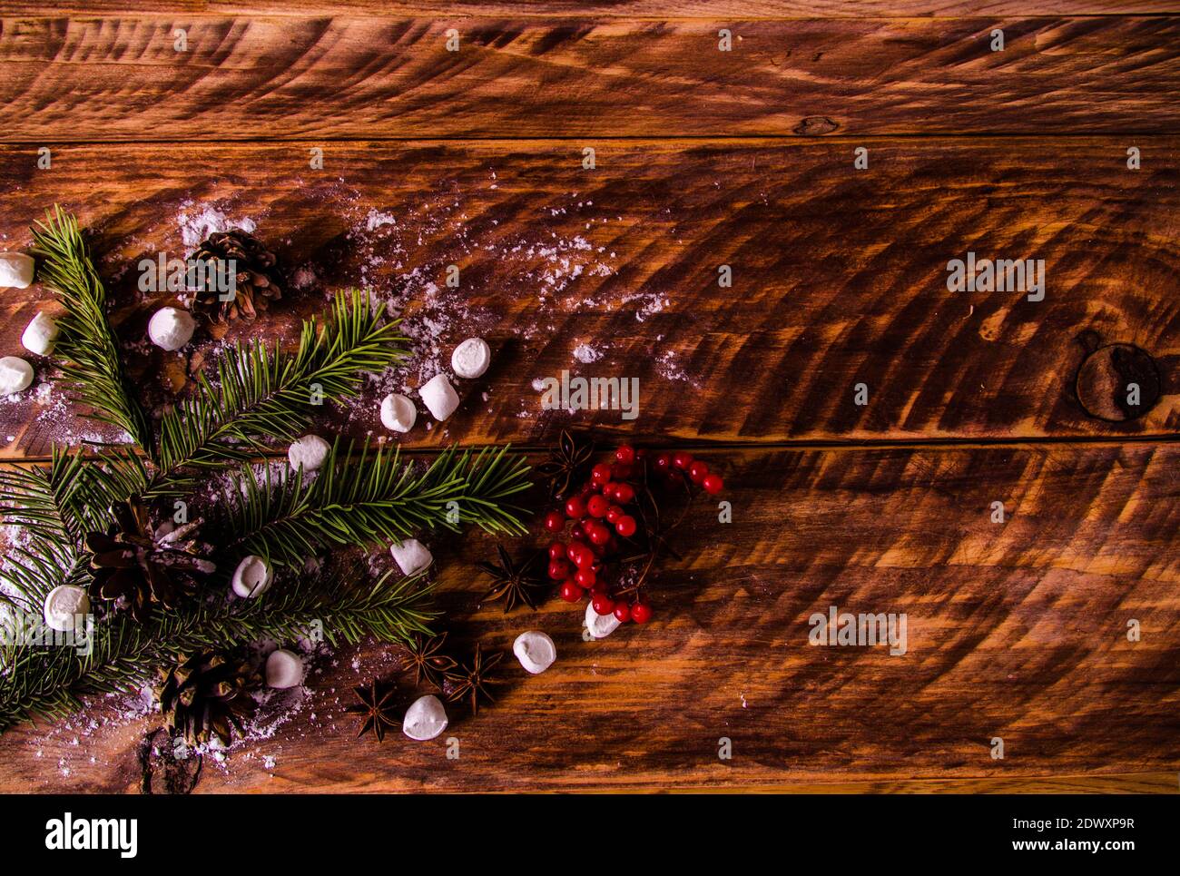 red viburnum. Christmas cones and branches on wooden boards with ...