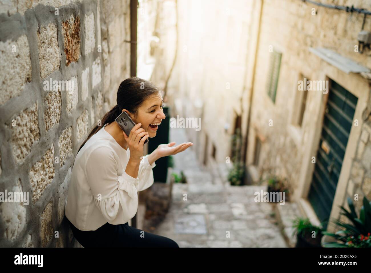 Excited laughing woman having a chat call meeting.Using a social network platform to stay connected.Smartphone app technology for internet communicati Stock Photo