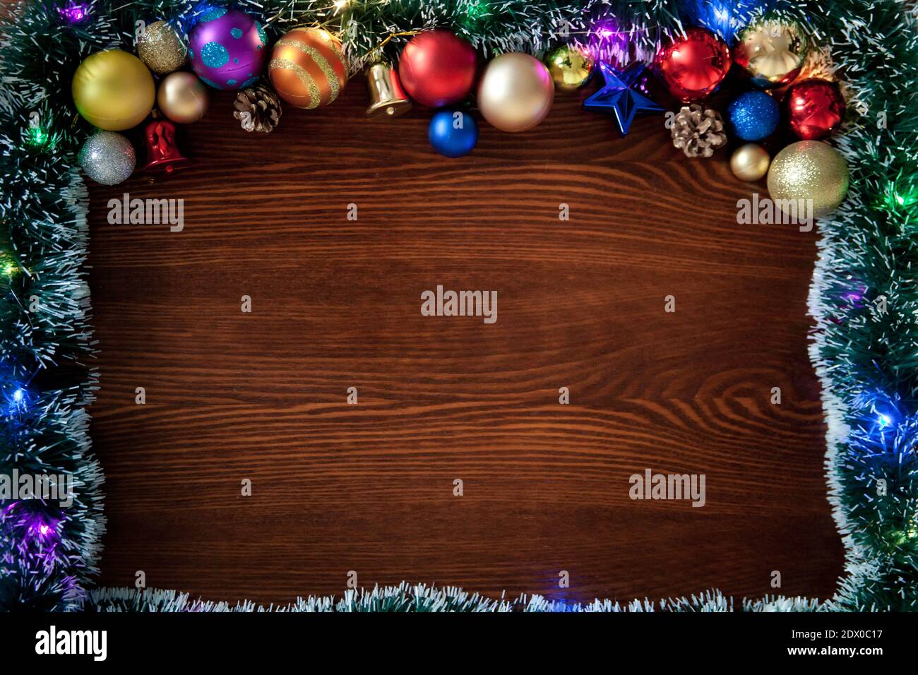 Christmas background, a table decorated with Christmas garland .With New Year and Christmas. Christmas rustic background - old wood with lights and fr Stock Photo