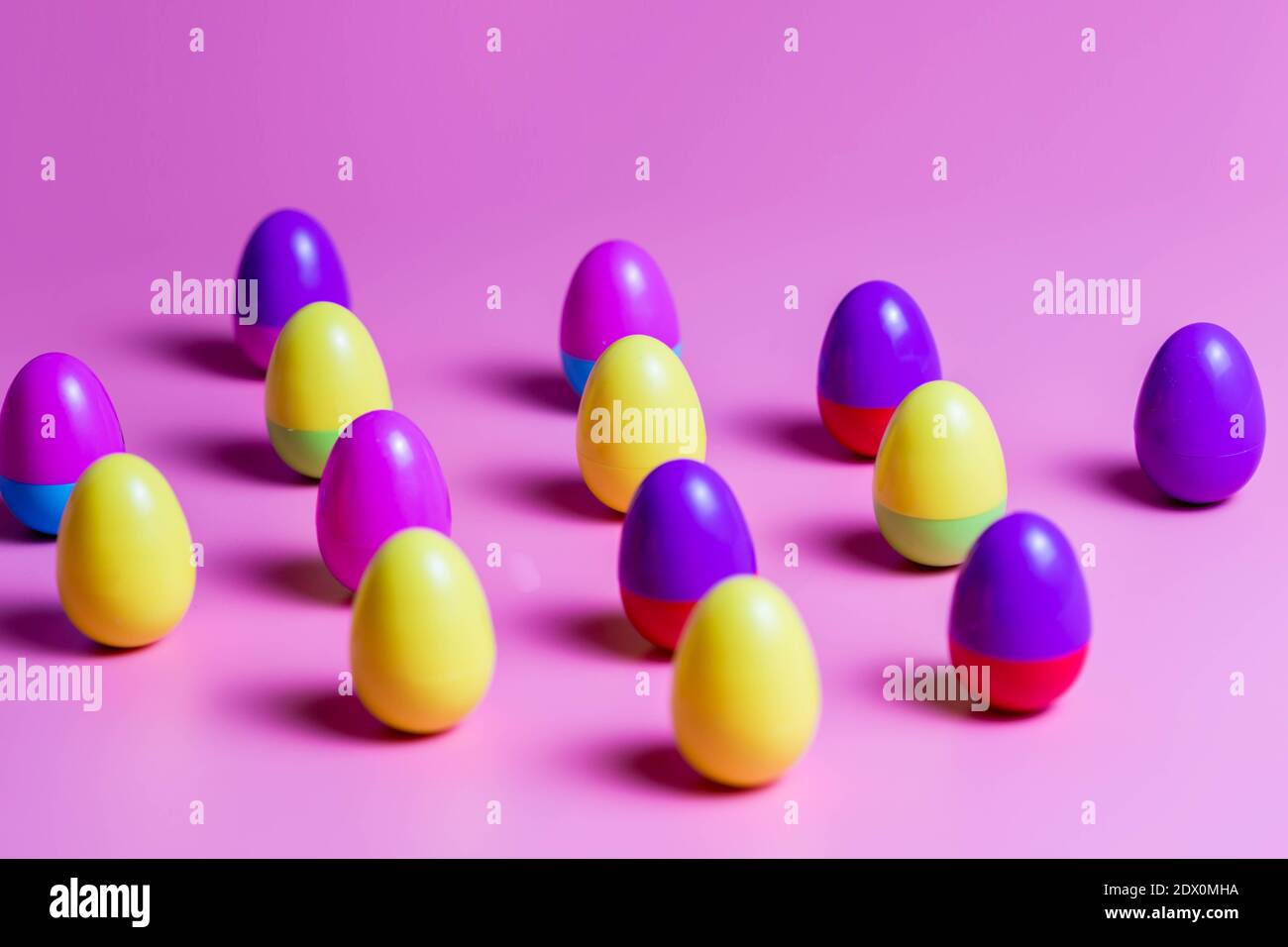 Colorful Plastic Easter Eggs on pink background Stock Photo