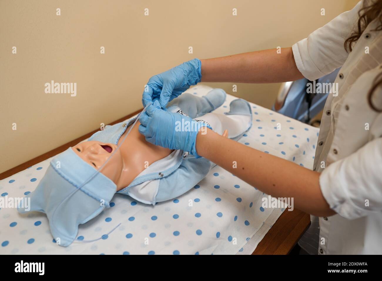 Female doctor with child mannequin in the hospital. Medical equipment