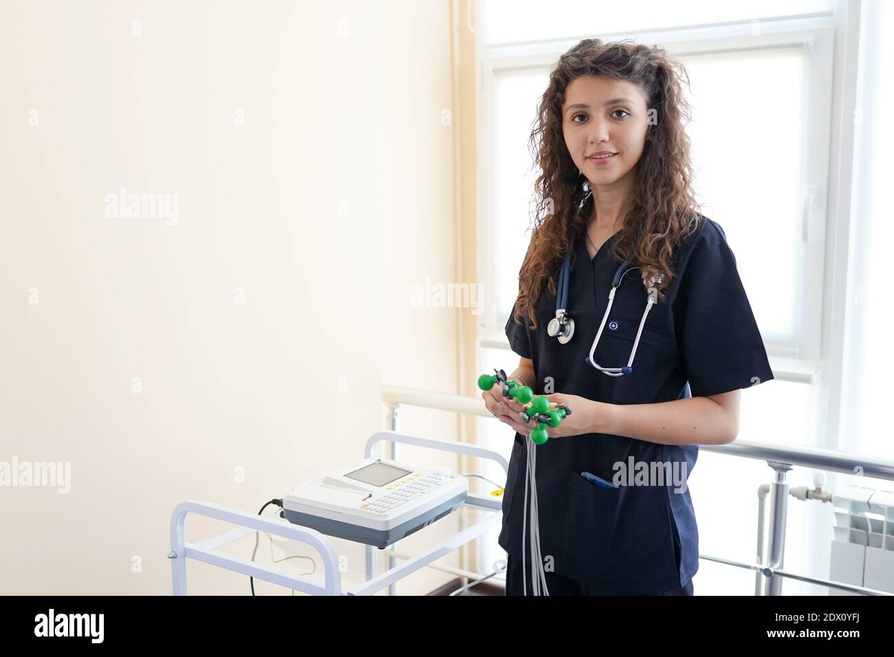 Cardiologist with electrocardiogram equipment in the cabinet, copy space Stock Photo