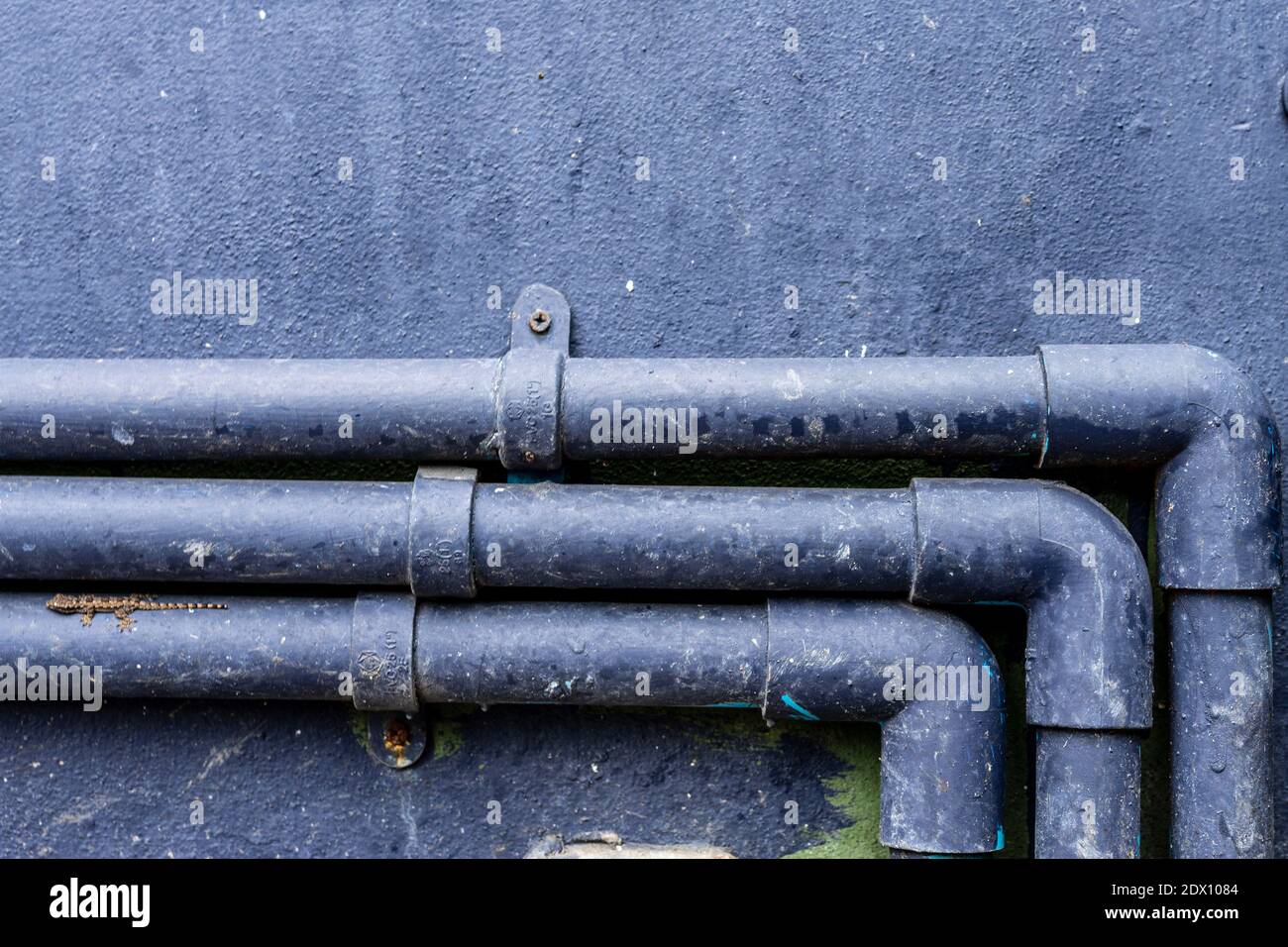Closeup Of Pipes Against Wall Stock Photo Alamy