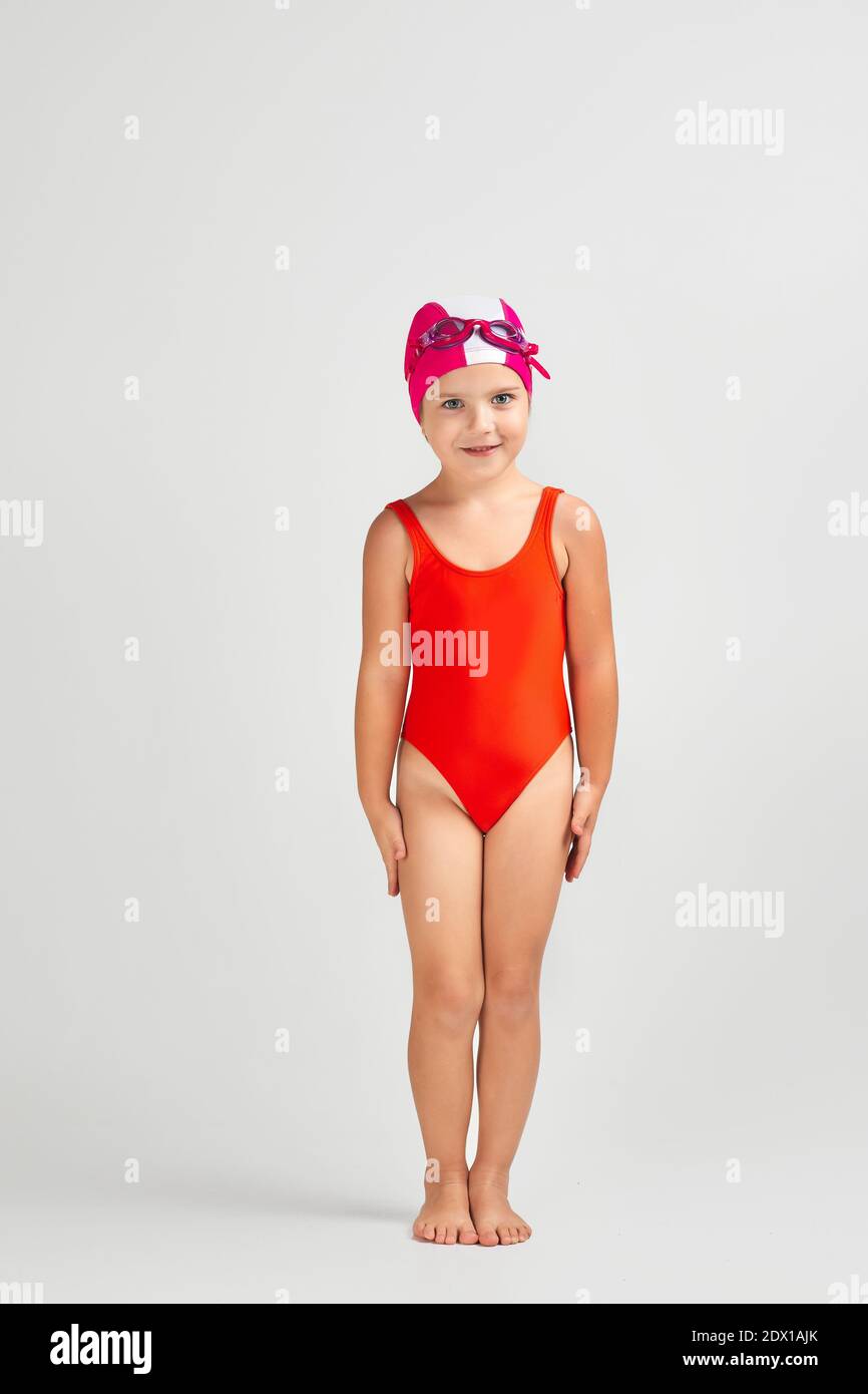 little child girl in swimsuit, swimming goggles and swim cap. Full length  Stock Photo - Alamy