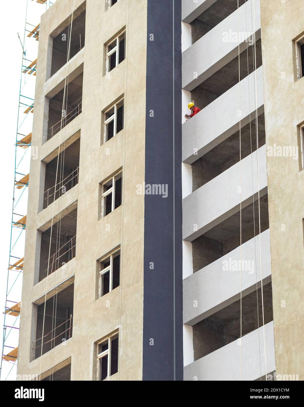 High buildings with scaffold at the construction site, painting a wall Stock Photo