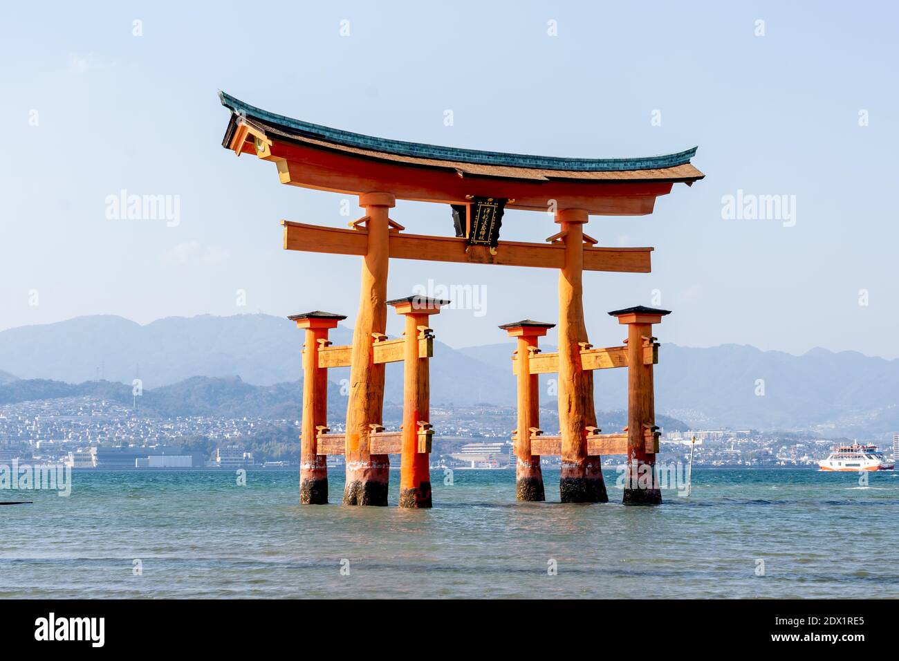 Floating torii gate in the water at Itsukushima Shrine (gate sign reads Itsukushima Shrine)in Hiroshima, Japan. Stock Photo