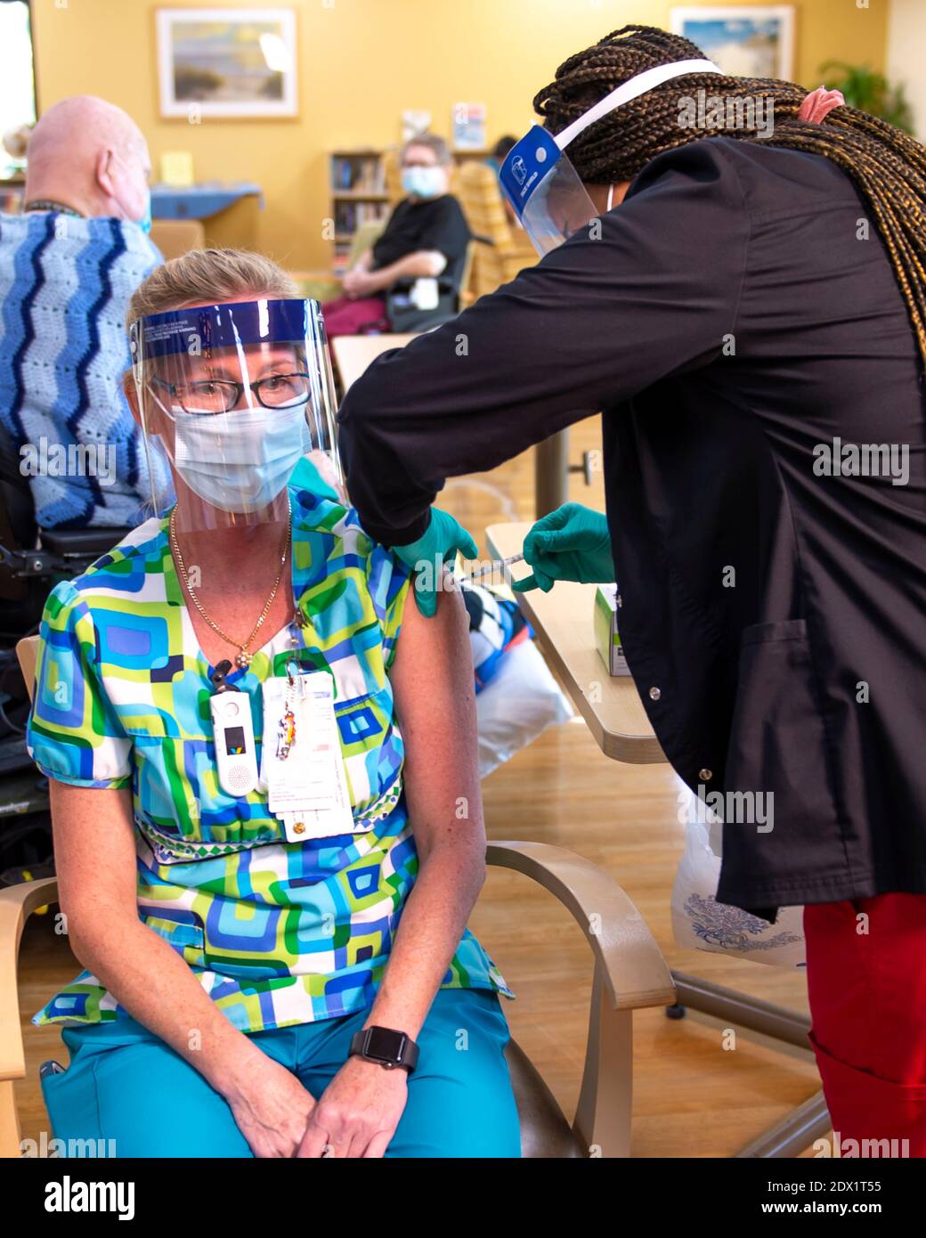 A nurse at the Bay Pines VA Healthcare System Community Living Center receives a COVID-19 vaccine December 22, 2020 in Bay Pines, Florida. Stock Photo