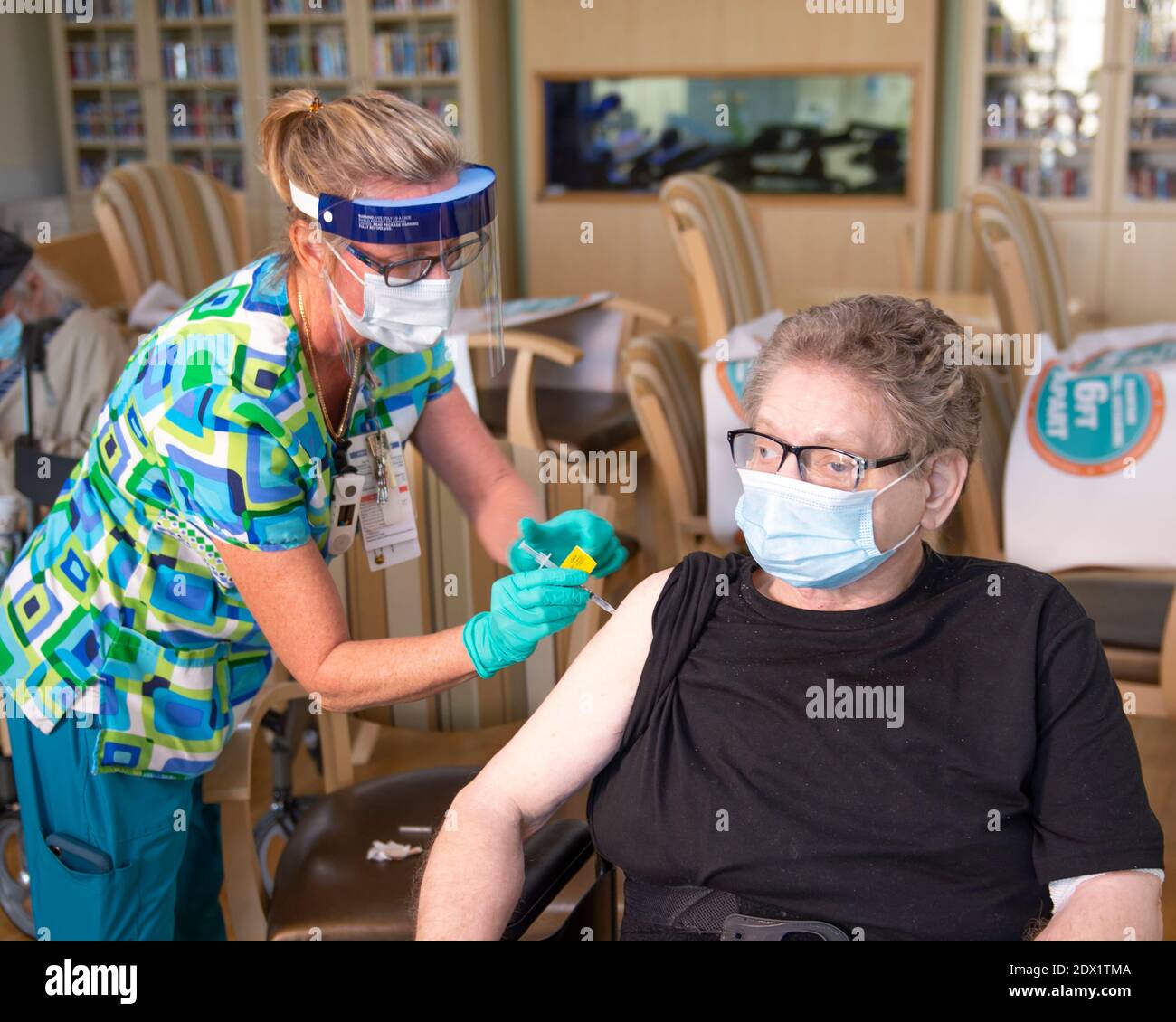 A U.S. Navy veteran resident of the Bay Pines VA Healthcare System Community Living Center receives a COVID-19 vaccine December 22, 2020 in Bay Pines, Florida. Stock Photo