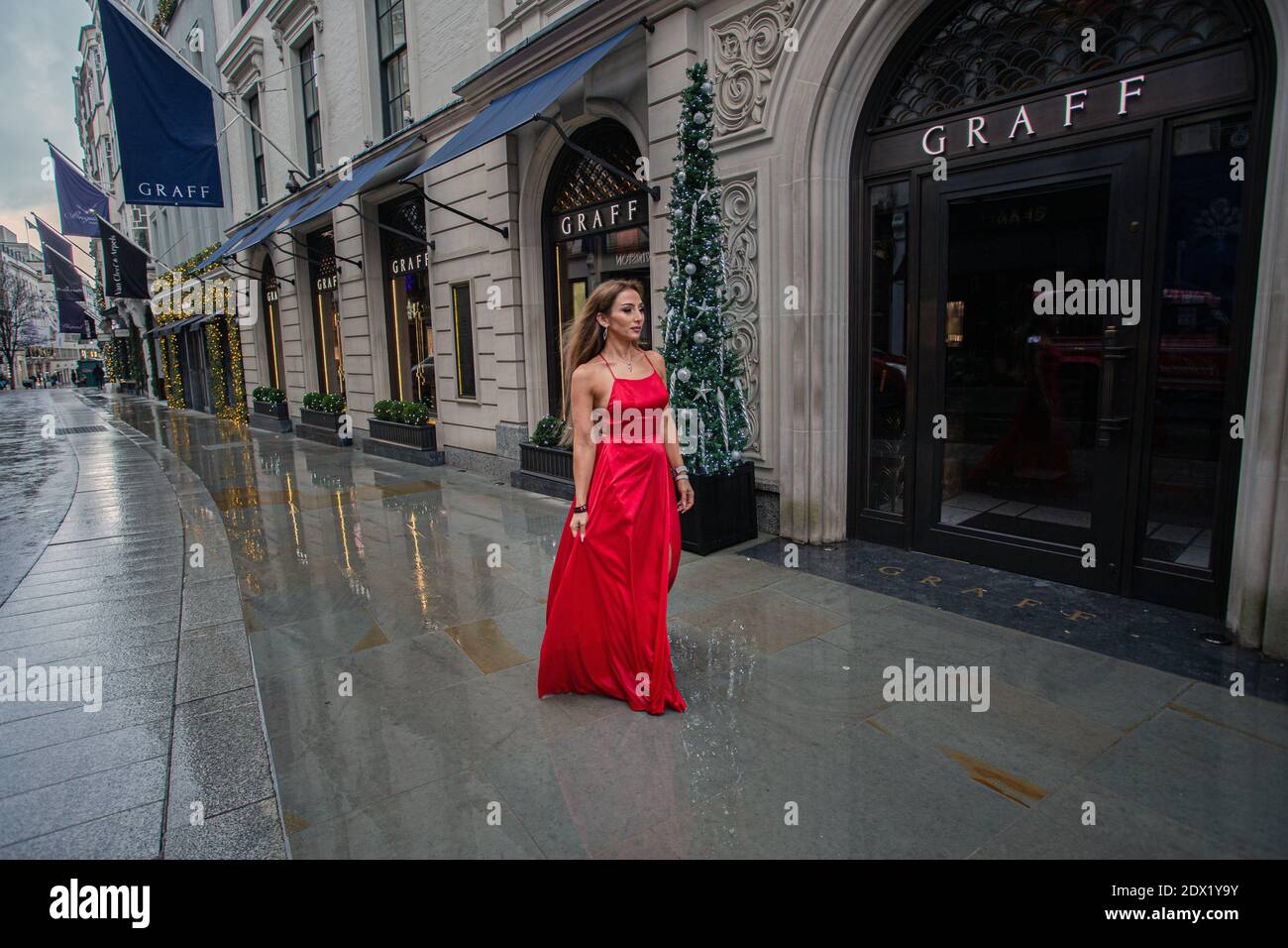 Great Britain /London / Mary Yan Instagram Influencer gets her photos taken walking in red dress in Bond Street on December 23, 2020 in London. Stock Photo
