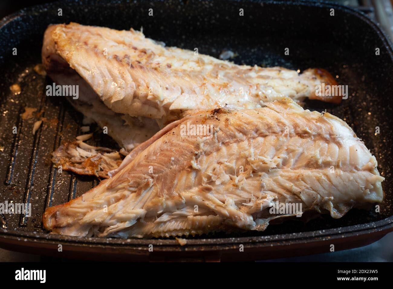Cooking sea bass in a pan Stock Photo Alamy
