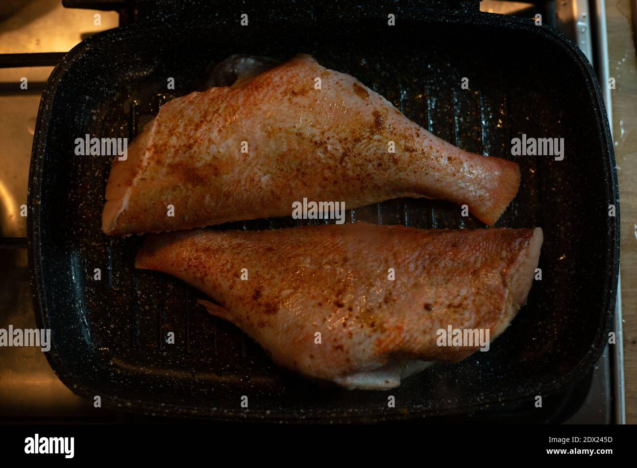 Cooking sea bass in a pan Stock Photo Alamy