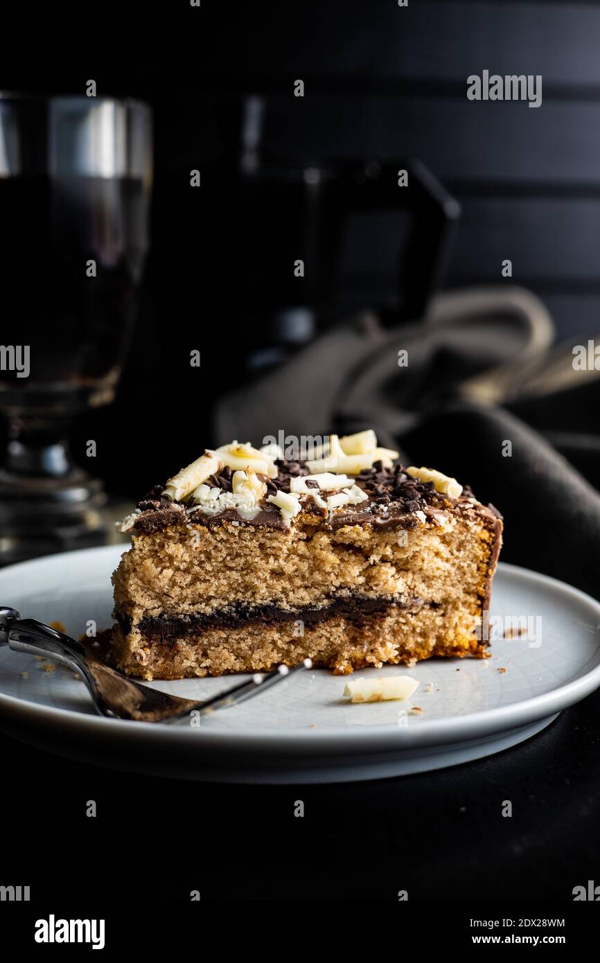 Sweet chocolate pie. Cake with chocolate sprinkles on black table. Stock Photo