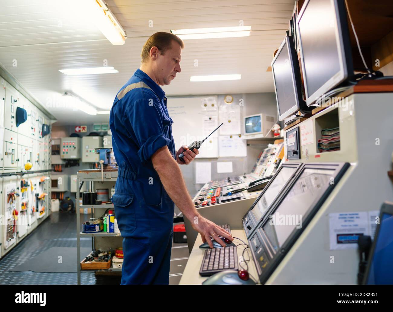 Marine Engineer working on radio communication at Engine Control room ECR  Stock Photo - Alamy