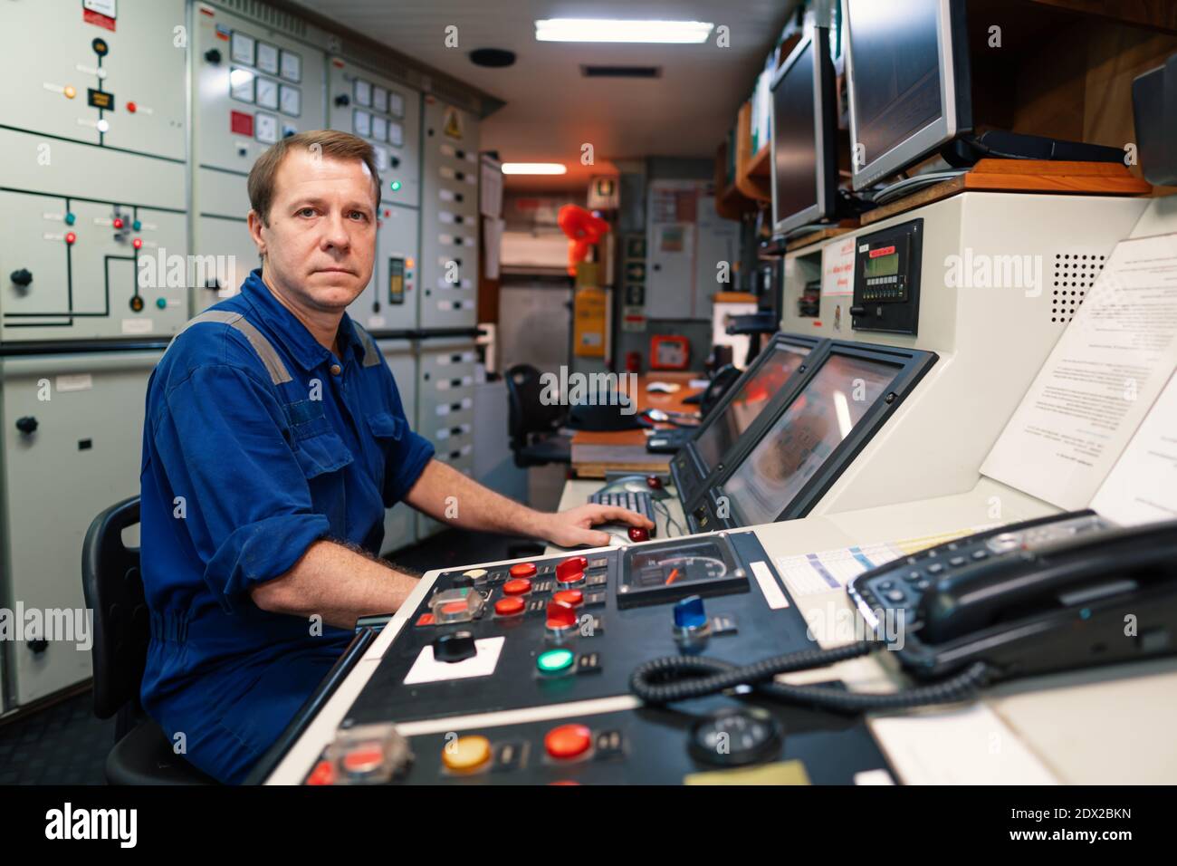 Marine engineer officer controlling vessel engines and propulsion in ...