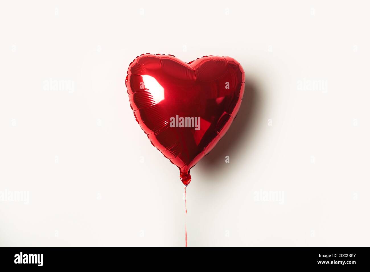 red air balloon in the form of a heart on a white background Stock ...