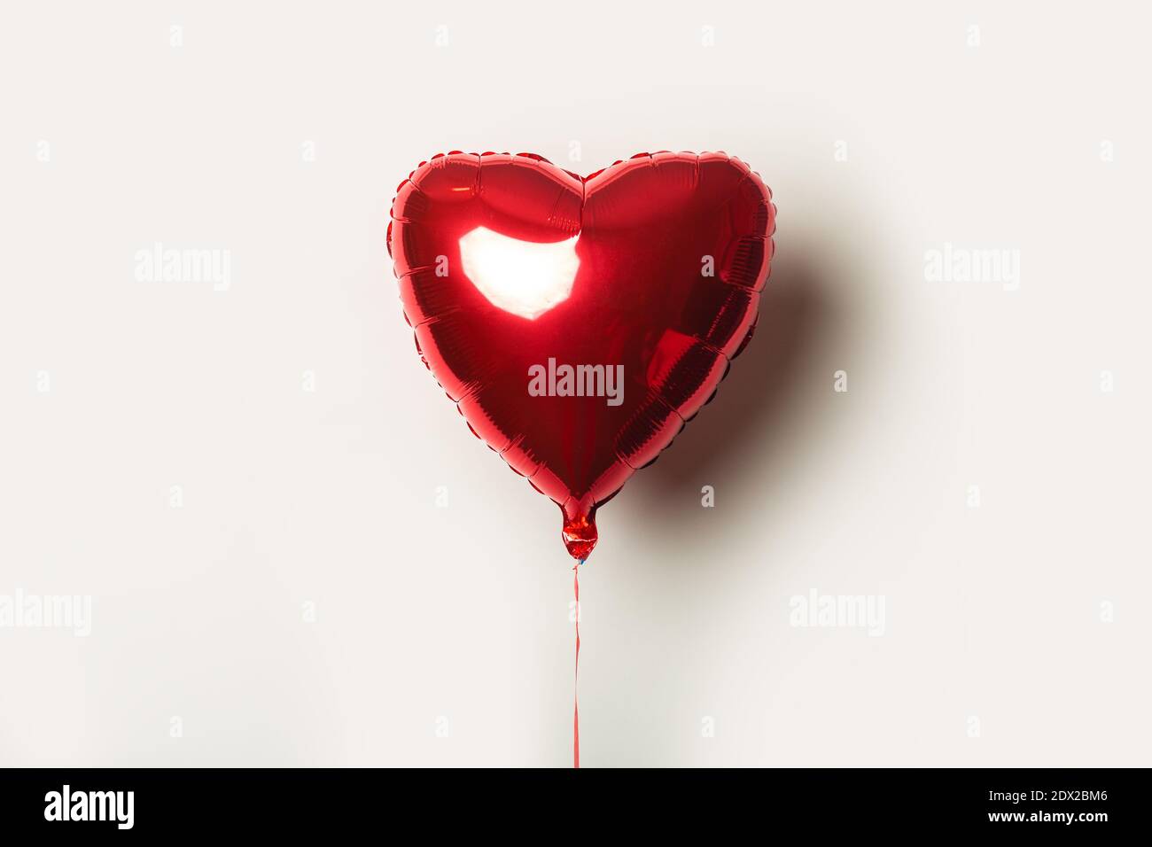 red air balloon in the form of a heart on a white background Stock ...