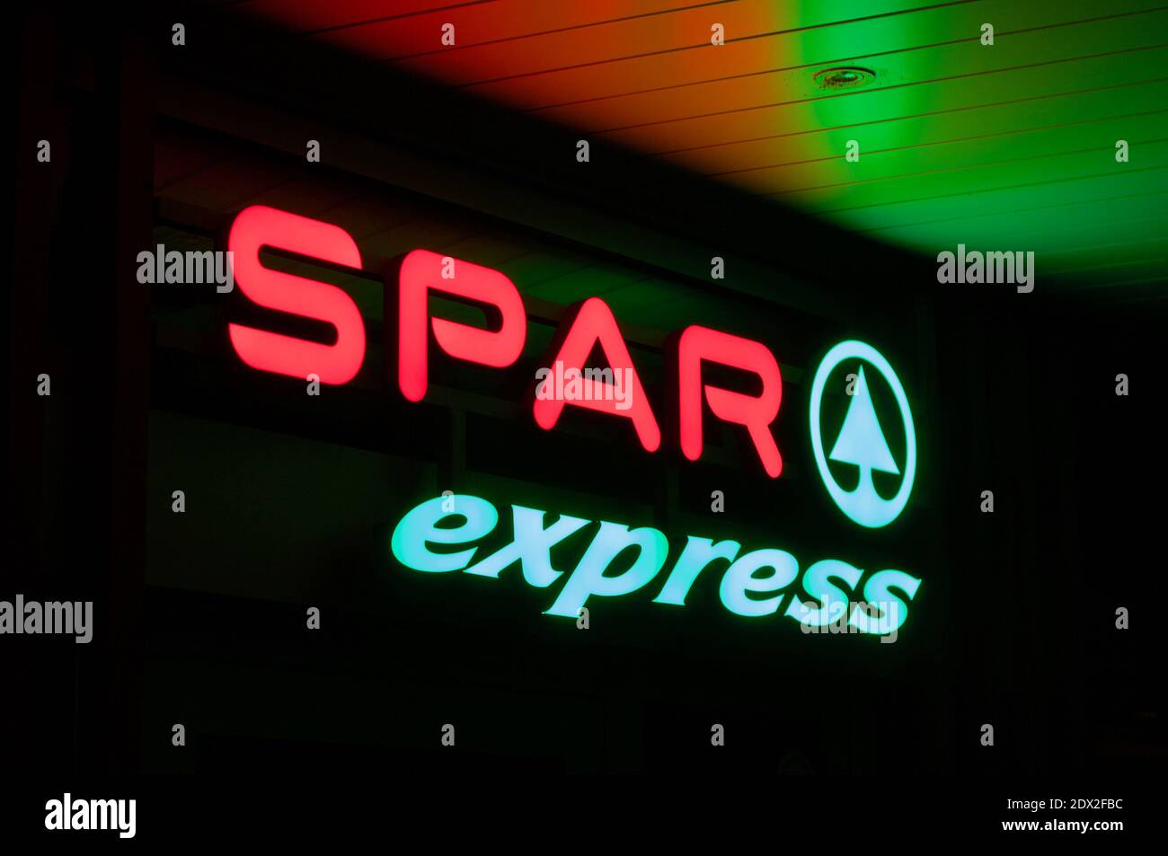 Lugano, Ticino, Switzerland - 27th November 2020 : Luminous Spar Express supermarket sign hanging on a store in Lugano. SPAR is a Dutch multinational Stock Photo