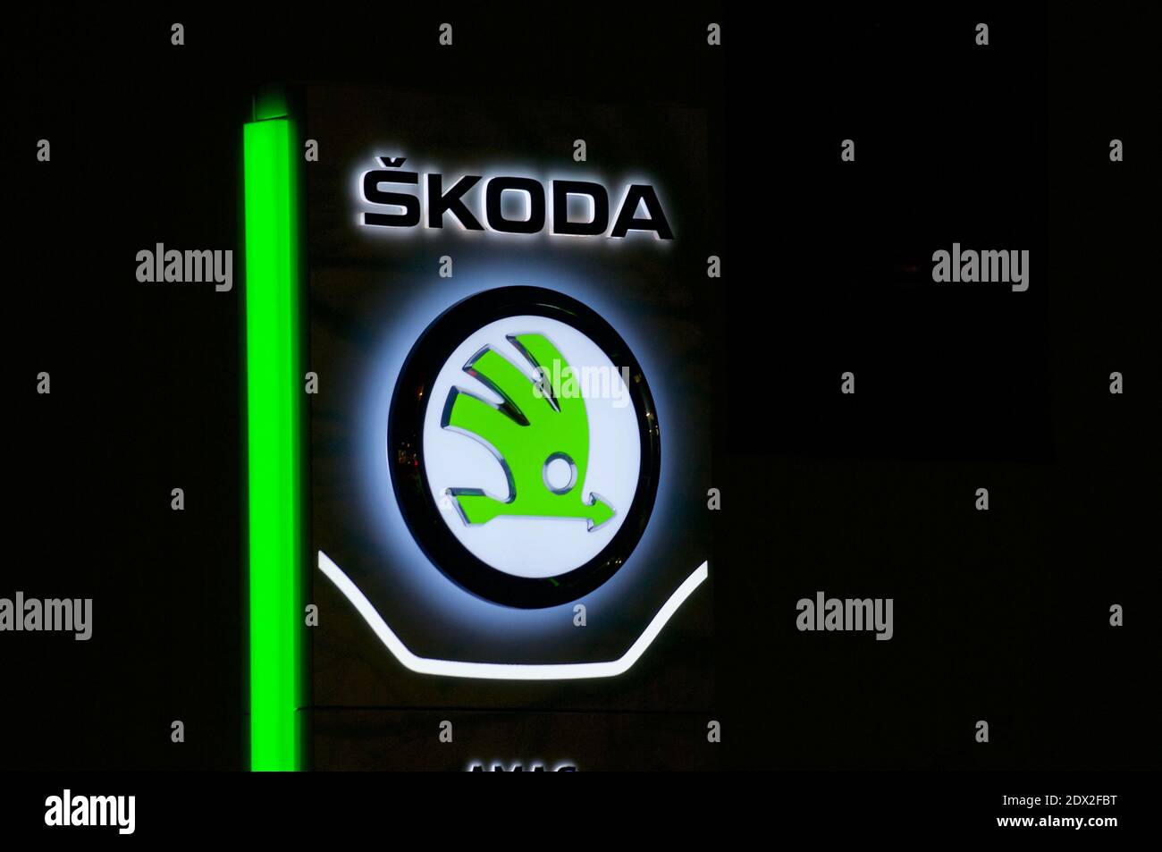 Lugano, Ticino, Switzerland - 3rd December 2020 : Luminous Czech Skoda car dealership logo hanging in front of the garage building in Lugano. is a Cze Stock Photo