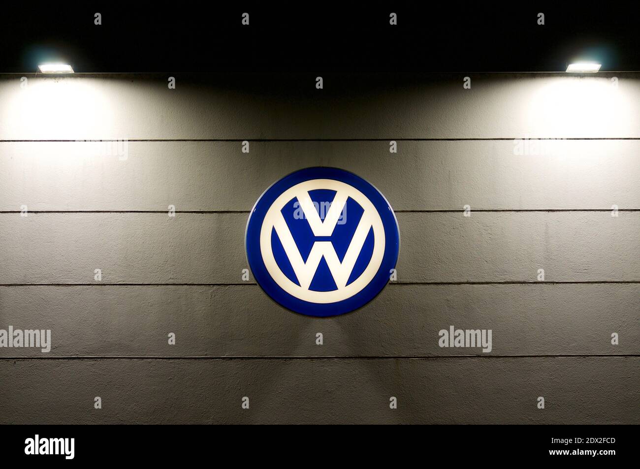 Lugano, Ticino, Switzerland - 3rd December 2020 : Luminous VW logo sign of Volkswagen AG haning on a dealership store in Lugano. VW is one of the worl Stock Photo