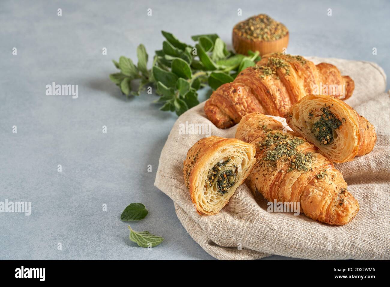 Croissants with zaatar on linen napkin board. Closeup  , copy space Stock Photo