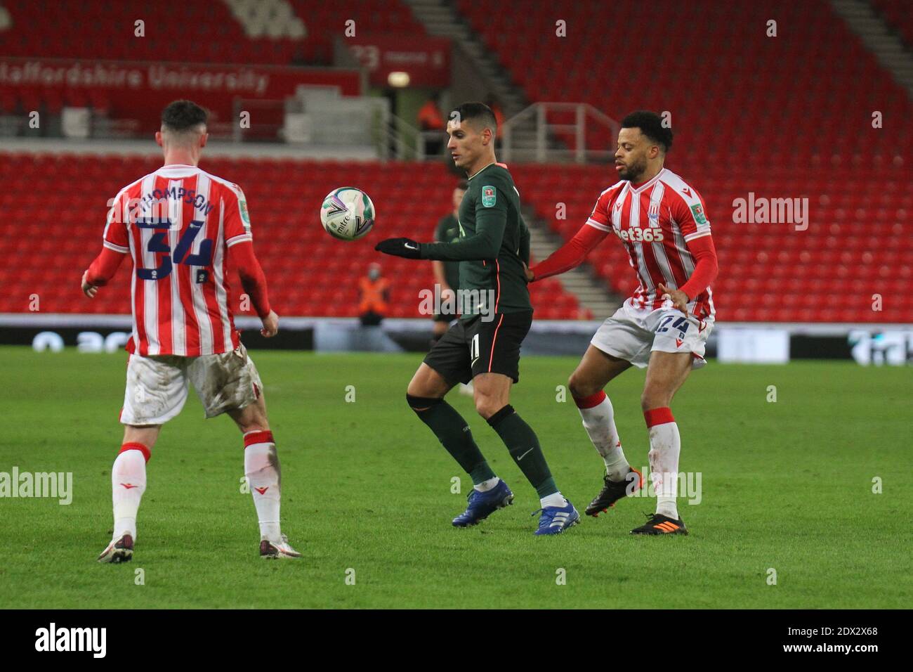 STOKE ON TRENT, ENGLAND. WEDNESDAY 23RD DECEMBER. Erik Lamela of Tottenham Hotspur controls the ball against Jordan Thompson of Stoke City and Jordan Cousins of Stoke City during the Carabao Cup Quarter Final match between Stoke City and Tottenham Hotspur at the Britannia Stadium, Stoke-on-Trent on Wednesday 23rd December 2020. (Credit: Simon Newbury | MI News) Credit: MI News & Sport /Alamy Live News Stock Photo