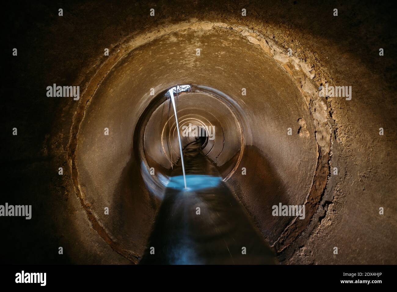 Dark underground sewer round concrete tunnel. Industrial wastewater and