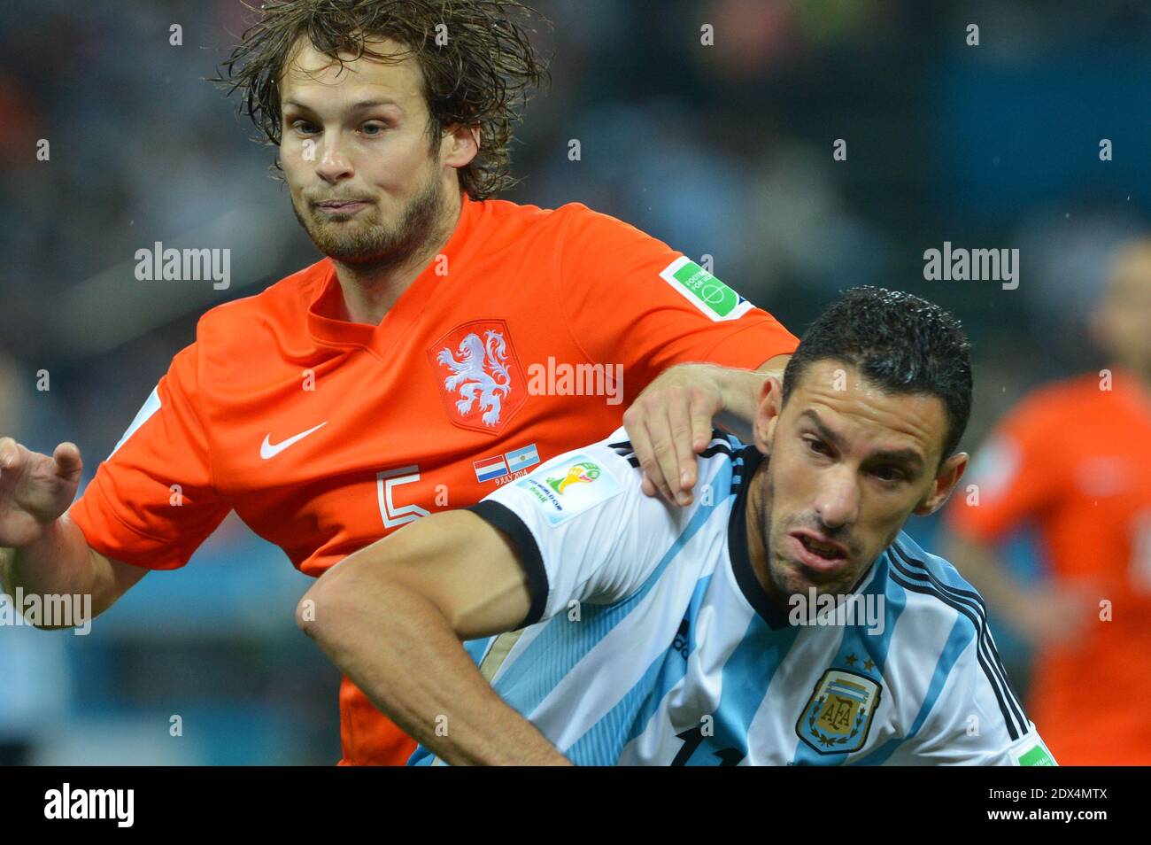 Netherlands's Daley Blind battling Argentina's Maxi Rodriguez during Soccer World Cup Semi Final match Netherlands v Argentina at Itaquera Stadium, Sao Paulo, Brazil on July 9, 2014. Argentina won on the penalty shoot-out 5-3 after a 0-0 score. Photo by Henri Szwarc/ABACAPRESS.COM Stock Photo