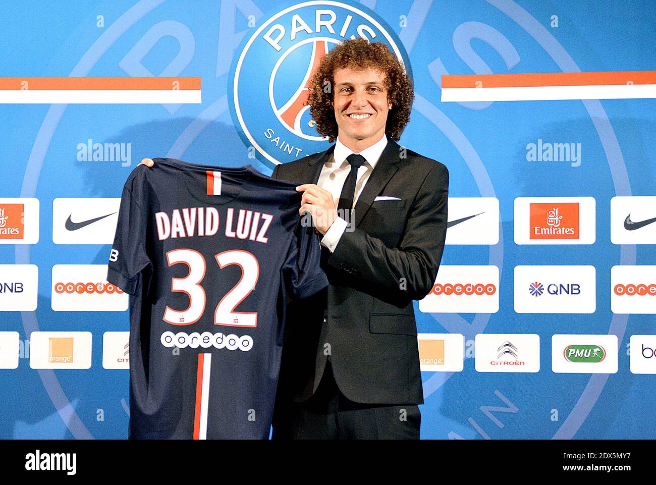 PSG (Paris Saint-Germain) newly recruited Brazilian defender David Luiz  holds his new jersey during his official presentation at hotel Peninsula in  Paris, France on August 7, 2014. Luiz, aged 27, signed in