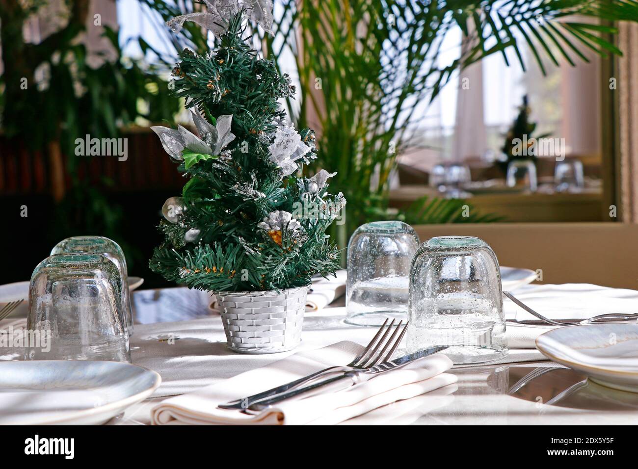 Beautifully decorated Christmas tree with dining table set up Stock Photo