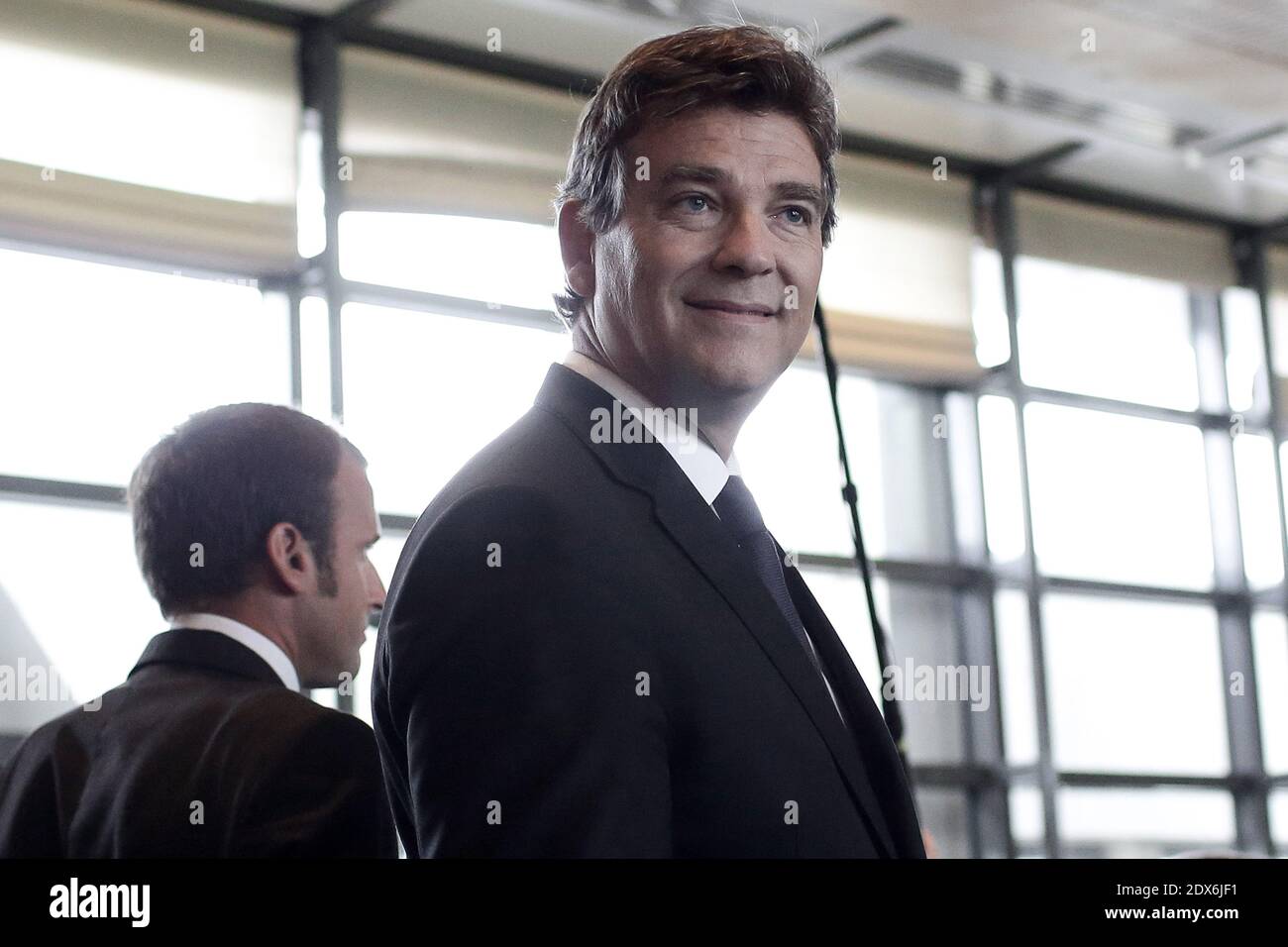 Outgoing French Economy Minister Arnaud Montebourg and his newly appointed successor Emmanuel Macron, a 36-year-old ex-Rothschild banker and architect of the president's economic policy, during a handover cermony in Paris, France on August 27, 2014 at the Economy Ministry. Photo by Stephane Lemouton/ABACAPRESS.COM Stock Photo