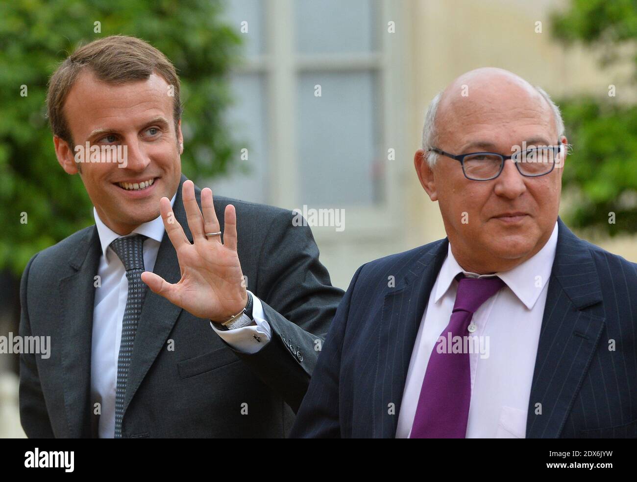 French Finance Minister Michel Sapin and newly-appointed Economy Minister Emmanuel Macron arriving at the Elysee presidential palace in Paris, France before a weekly cabinet meeting. French President Francois Hollande on August 27 installed a former banker and ally as economy minister in an emergency reshuffle seen as the 'last chance' to haul France out of the biggest crisis of his presidency. Hollande caught everyone off guard with the appointment of Emmanuel Macron, a 36-year-old ex-Rothschild banker and architect of the president's economic policy. Photo by Christian Liewig/ABACAPRESS.COM Stock Photo