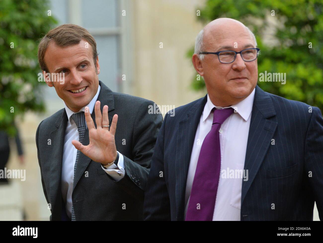 French Finance Minister Michel Sapin and newly-appointed Economy Minister Emmanuel Macron arriving at the Elysee presidential palace in Paris, France before a weekly cabinet meeting. French President Francois Hollande on August 27 installed a former banker and ally as economy minister in an emergency reshuffle seen as the 'last chance' to haul France out of the biggest crisis of his presidency. Hollande caught everyone off guard with the appointment of Emmanuel Macron, a 36-year-old ex-Rothschild banker and architect of the president's economic policy. Photo by Christian Liewig/ABACAPRESS.COM Stock Photo