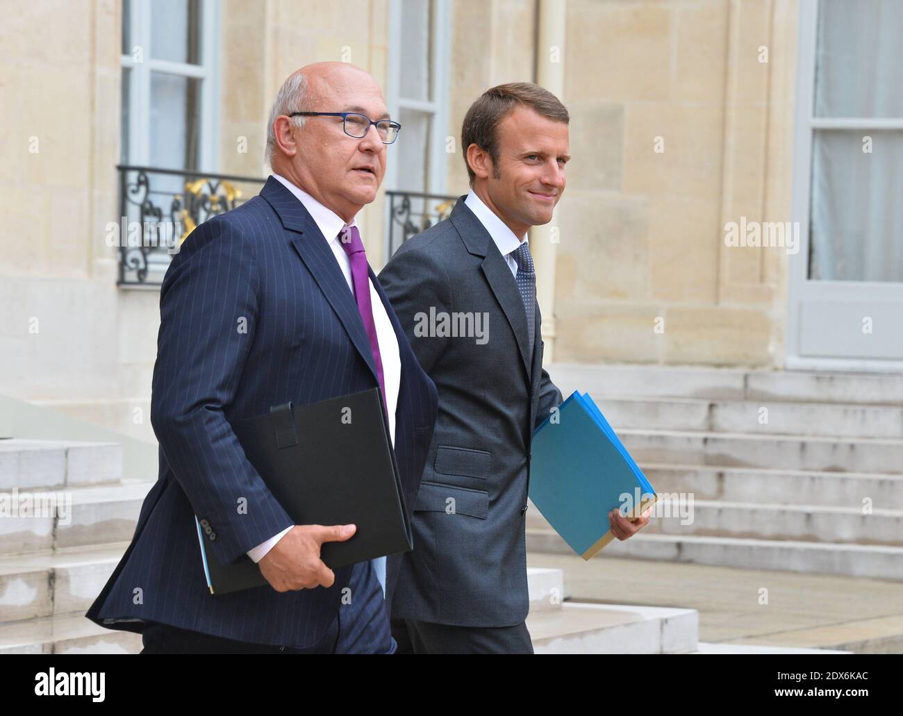 French Finance Minister Michel Sapin and newly-appointed Economy Minister Emmanuel Macron leaving the Elysee presidential palace in Paris, France after a weekly cabinet meeting. French President Francois Hollande on August 27 installed a former banker and ally as economy minister in an emergency reshuffle seen as the 'last chance' to haul France out of the biggest crisis of his presidency. Hollande caught everyone off guard with the appointment of Emmanuel Macron, a 36-year-old ex-Rothschild banker and architect of the president's economic policy. Photo by Christian Liewig/ABACAPRESS.COM Stock Photo