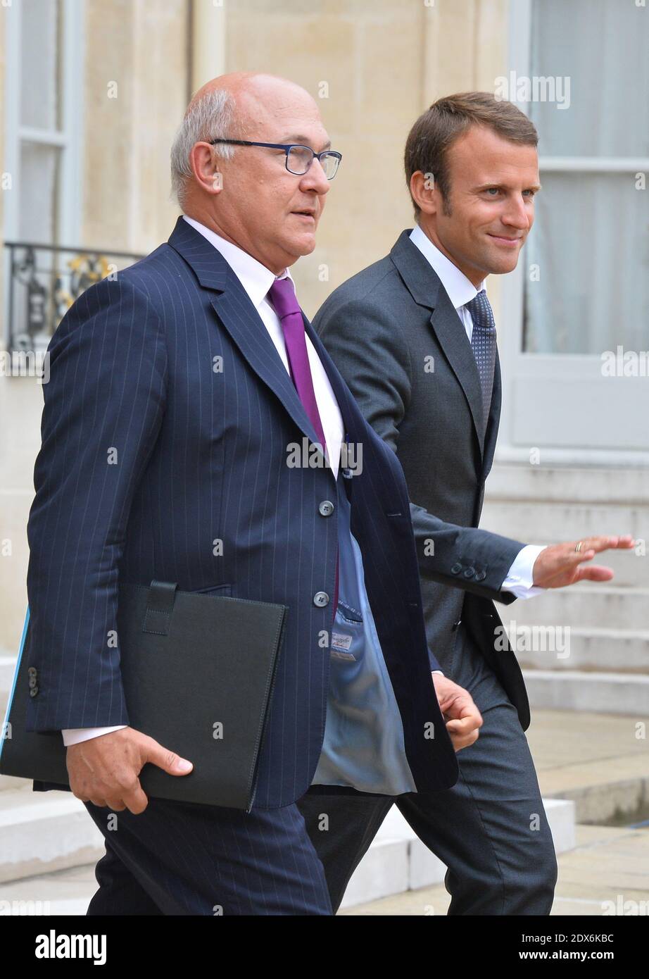 French Finance Minister Michel Sapin and newly-appointed Economy Minister Emmanuel Macron leaving the Elysee presidential palace in Paris, France after a weekly cabinet meeting. French President Francois Hollande on August 27 installed a former banker and ally as economy minister in an emergency reshuffle seen as the 'last chance' to haul France out of the biggest crisis of his presidency. Hollande caught everyone off guard with the appointment of Emmanuel Macron, a 36-year-old ex-Rothschild banker and architect of the president's economic policy. Photo by Christian Liewig/ABACAPRESS.COM Stock Photo