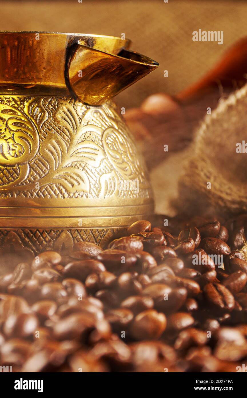 Golden cezve with freshly roasted coffee. Stock Photo