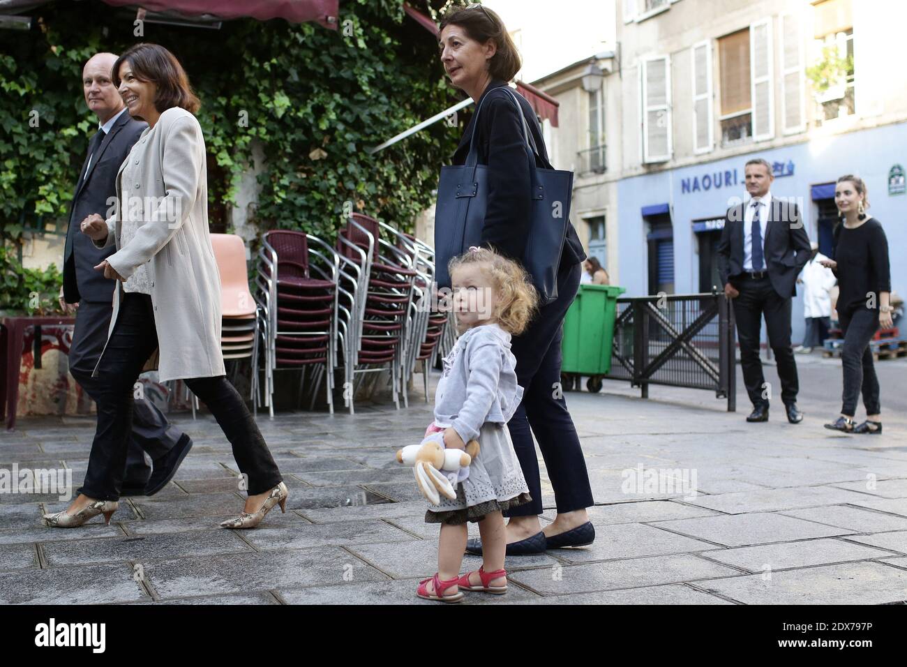 A mother with her daughter arrive next to Paris Mayor Anne Hidalgo and Paris Mayor district 4th, Christophe Girard to the start of the new school year (rentree scolaire) in the 4th district of Paris, France, on September 02, 2014. Photo by Stephane Lemouton/ABACAPRESS.COM Stock Photo