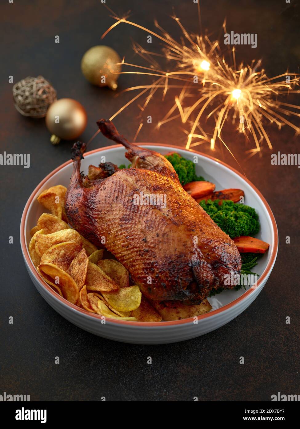 freshly roasted duck roast with vegetables in white ceramic serving